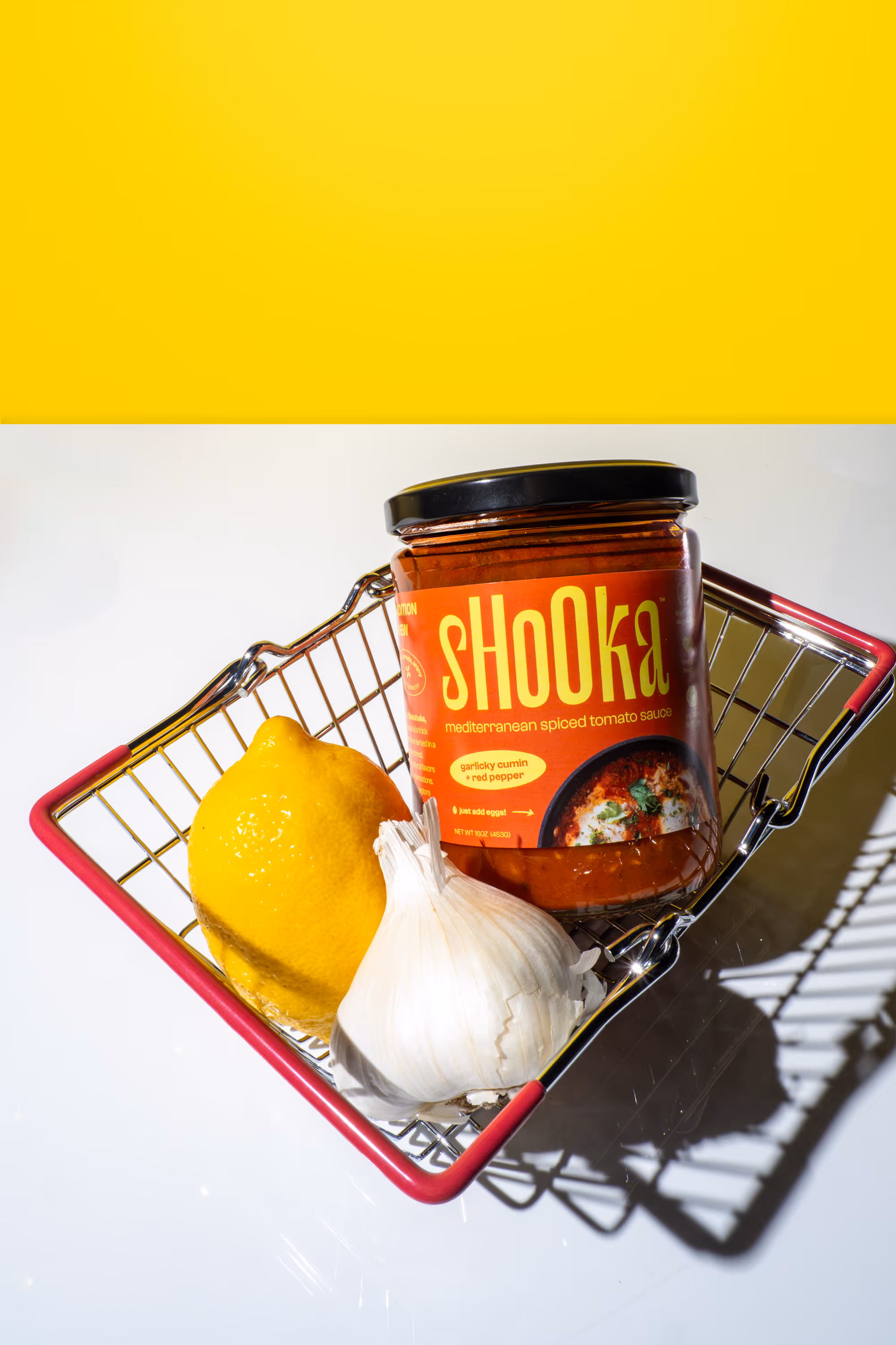 shOOka tomato sauce, lemon, and garlic in a basket.